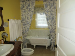 Spacious bathroom featuring a clawfoot tub.