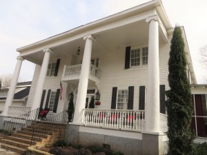 Exterior of the Bama B & B campus location with columns originally intended for a university building.