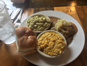 Hamburger steak with sauteed onions, creamed corn and butter beans.