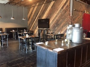 Part of the interior showing the re-purposed wood walls and concrete floors.