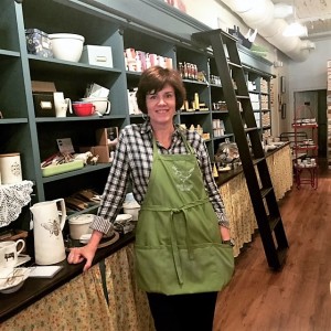 Owner Christy Keyton posing by one of her favorite display walls in the store.