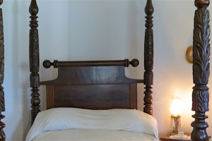 Destrehan bed with rolling pin for smoothing the mattress