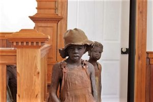 Statues of slave children by Woodrow Nash.