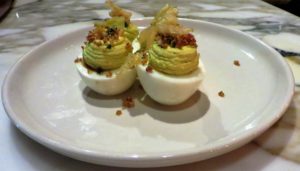 Deviled eggs with anchovy, curtido, and romesco.