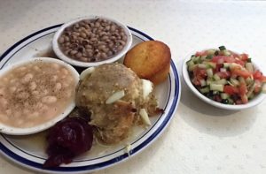 Chicken and dressing, black-eyed peas, Great Northern beans, tomato/cucumber salad, cornbread.