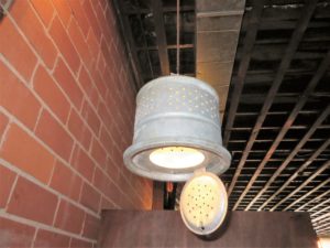 Upside-down minnow buckets used as light fixtures.