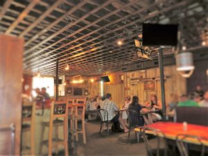 Casual interior of The Hound with lots of wood and openness.