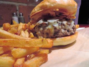 Bison Burger, mushrooms, Swiss cheese and tobacco onions with fries.