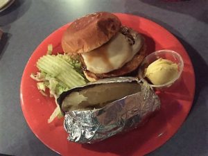 Veggie patty, topped with pineapple and mozzarella with a baked potato.