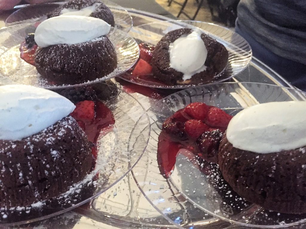 Chocolate lava cake with whipped cream and berries.