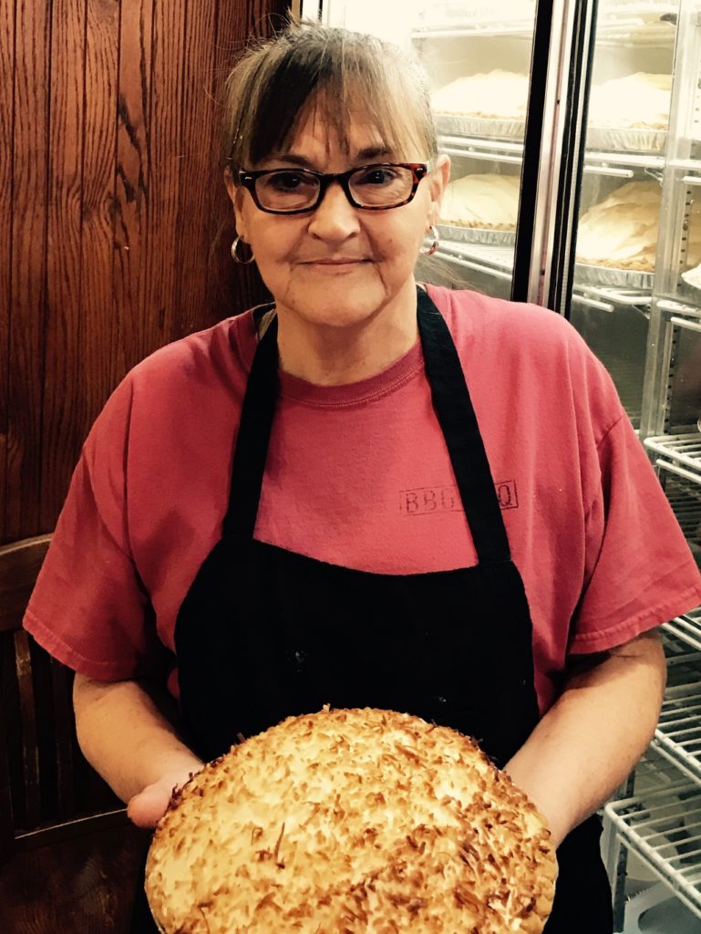 Jo Ann Gunner holds one of the popular coconut pies she just finished making.